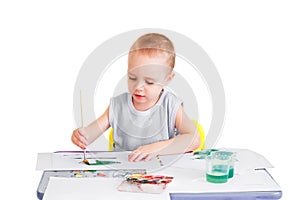 Boy paints watercolors