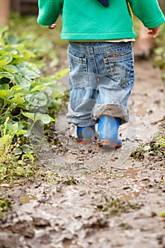 Boy palaying in mud