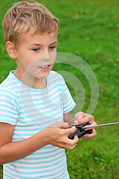 Boy with panel for radio control in hands