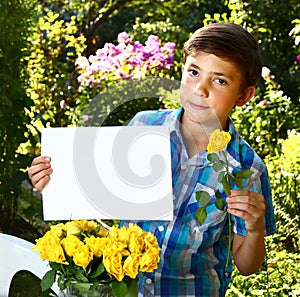 boy with paper sheet on the summer garden background