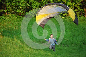 Boy and parachute near the ground