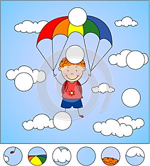 Boy parachutist descends from the sky on a parachute through the