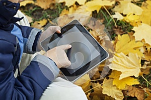 Boy in the park using a tablet PC