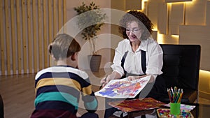 Boy patient and child therapist looking at drawing