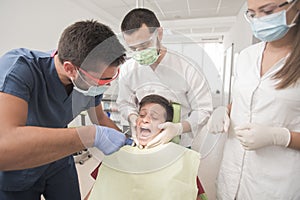 Boy with perfect teeth scared at the dentist