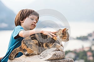 Boy petting a Cat on the wall of Kotor fortress