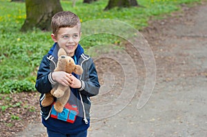 Boy photographer holds toy puppy