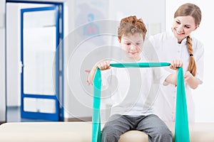 Boy and physical therapy in clinic photo