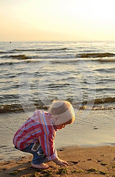 Boy picking up a stone