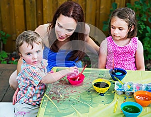 Boy Picks Up his New Dyed Pink Easter Egg