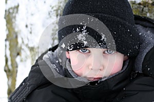 Boy piercing look in snow