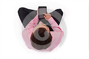 Boy in pink shirt sit and hold tablet PC