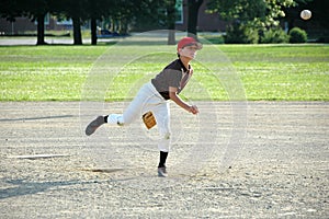 Boy pitching in youth baseball game