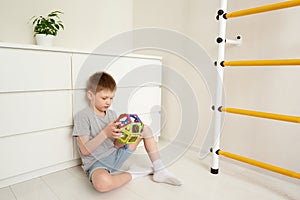 Boy plaing in a magnetic multicolored constructor