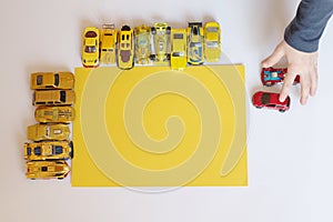 Boy plaing little yellow cars