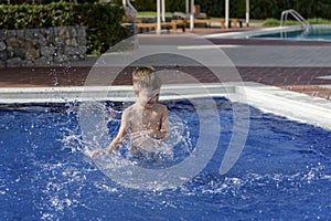 Boy plaiyng in swimming pool