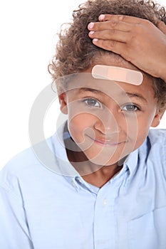 Boy with plaster on head