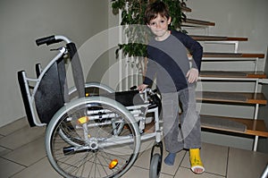 Boy with plaster leg limping to his wheelchair