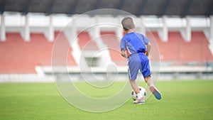 Boy play football in the ground