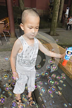 Boy play soapbubbles