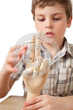 Boy is played by wooden hand of manikin isolated