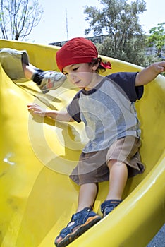 Boy on a playground slide