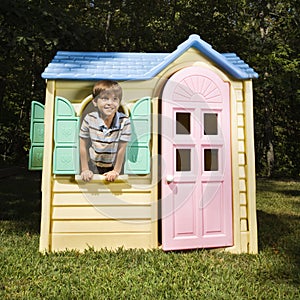 Boy in playhouse.