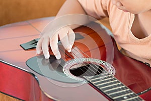 Boy playing a acoustic guitar