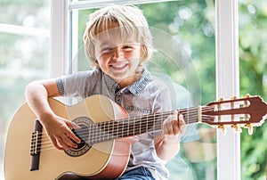 Boy playing acoustic guitar