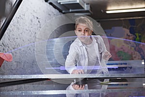 Boy playing on air hockey table