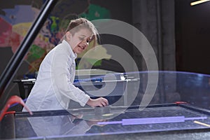 Boy playing on air hockey table