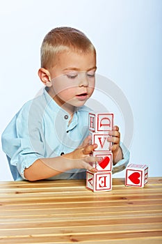 Boy playing with alphabet blocks