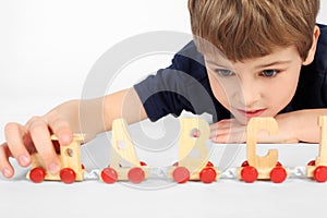 Boy playing with alphabet railway