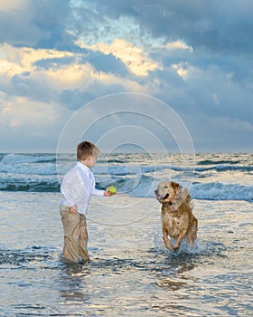 Boy playing ball with his dog