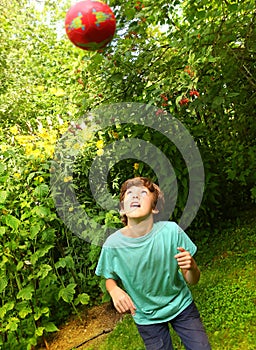 Boy playing with ball training soccer head blow