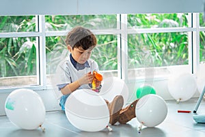 Boy playing balloons in birthday party