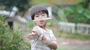Boy playing with bamboo dragonfly