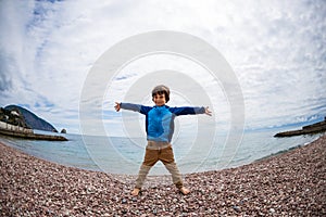 A boy is playing on the beach