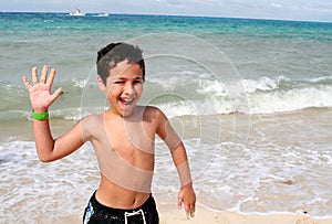 Boy Playing At Beach