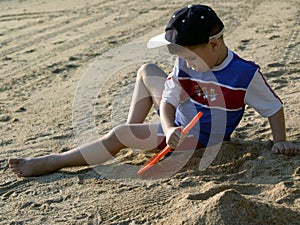 Boy playing on the beach photo