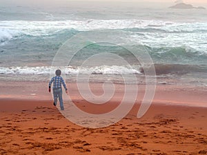 Boy playing on the beach