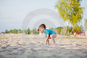 Boy playing on beach. Child play at sea on summer family vacation. Sand and water toys, sun protection for young child. Little boy