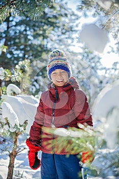 Boy playing in big snow in winter.