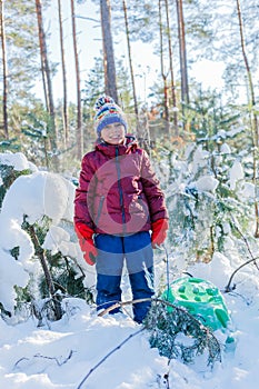 Boy playing in big snow in winter.