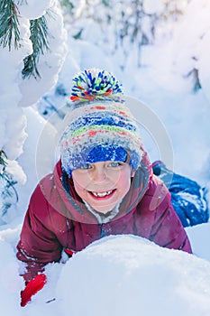 Boy playing in big snow in winter.