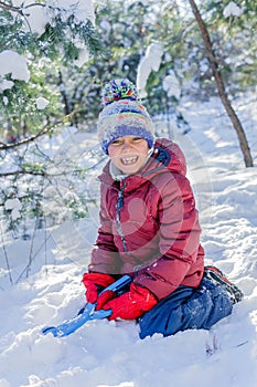 Boy playing in big snow in winter.