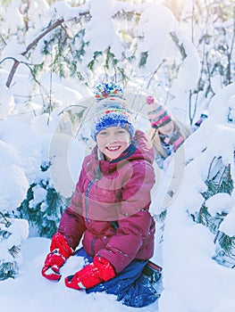 Boy playing in big snow in winter.