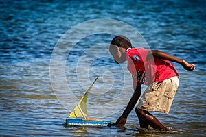 Boy playing with a boat