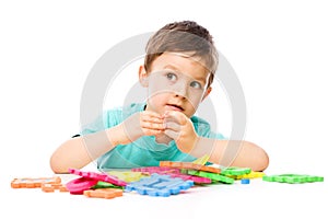 Boy is playing with building blocks