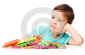 Boy is playing with building blocks